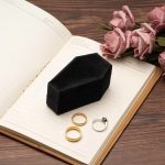 gothic-coffin-ring-box-on-journal-with-roses.jpeg